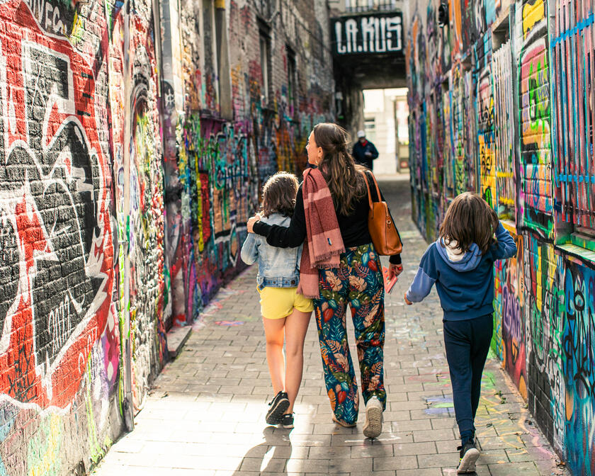 Family on a walk in the graffiti alley