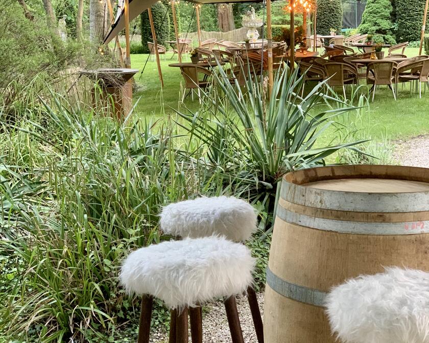 garden with bar stools around a beer barrel