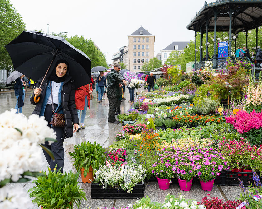 Fatina posiert neben Blumen auf dem Kouter in Gent