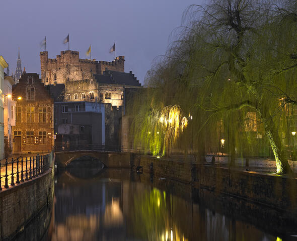 View of the illuminated Castle of the Counts from the Lievekaai in Ghent