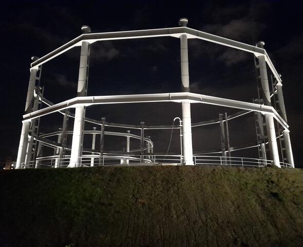 Illuminated pillars of the former gas holders on the Tondelier site in Ghent