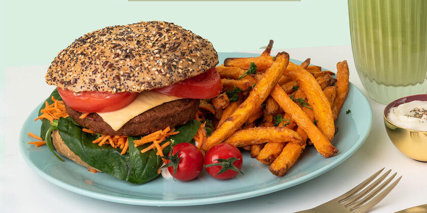 Tasty burger with sweet potato fries and a green shake