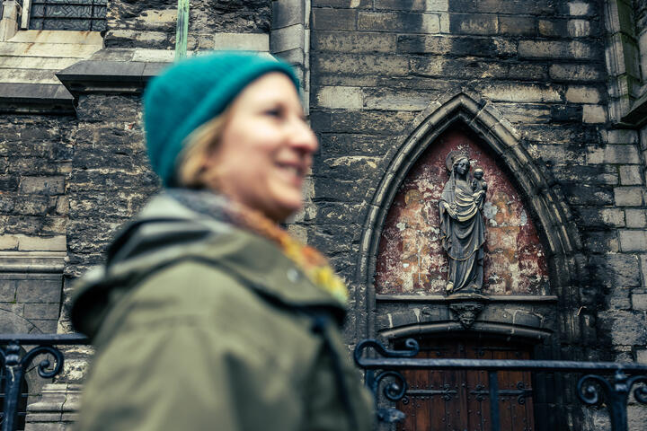 Maaike Blancke walks along the facades of St Bavo's Cathedral in Ghent