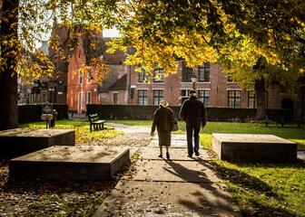 Elderly couple in a park during autumn.