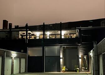 courtyard at dusk, with garage doors on left and right
