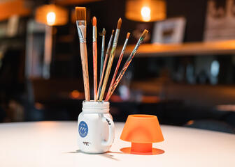 Brushes in a cup on a table