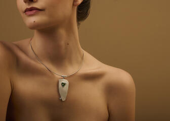 Model shows off necklace with large pendant