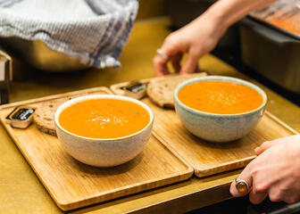 Two bowls of soup on a tray