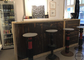 Bar with stools and stocked fridge with drinks
