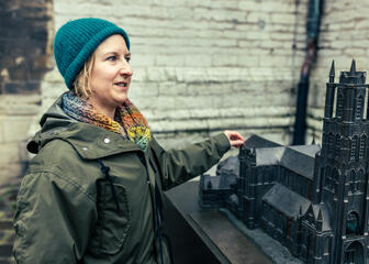 Maaike Blancke of Bressers Architects explains the cathedral using the model at the entrance of St Bavo's Cathedral.