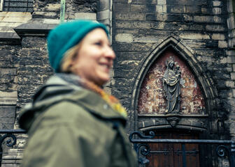 Maaike Blancke walks along the facades of St Bavo's Cathedral in Ghent