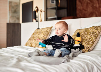 Child on bed in room