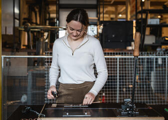 Woman works on a cutting machine