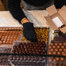 Woman fills a box of chocolates